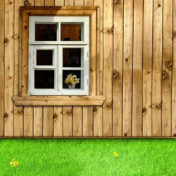 exterior of wooden house with window and green grass in the yard