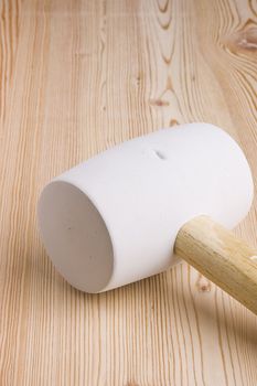 Woodworking mallet on a piece of wood.