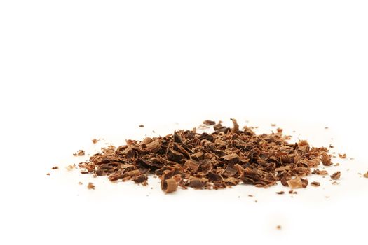 some chocolate crumbles on white background