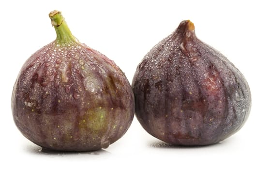 two wet fresh oriental figs on white background