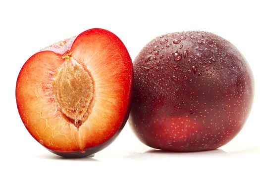 wet plum and a half on white background