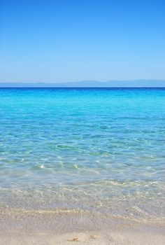 Armenistis beach in Sithonia, Chalkidiki, Greece, with view on Mt.Athos in distance.