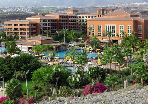 Big hotel with palms and pool on Costa Adeje, Tenerife