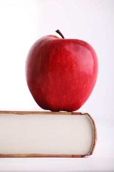 Red apple on the big book