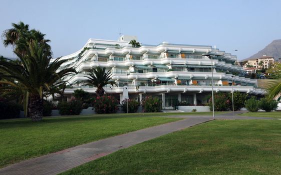 Big hotel with palms and stones around on Costa Adeje, Tenerife