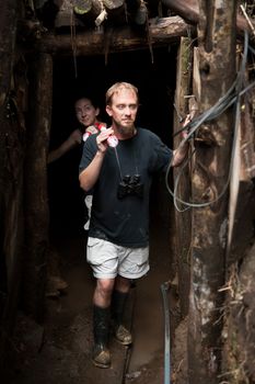 Couple exploring rustic abandoned gold mine in Costa Rica