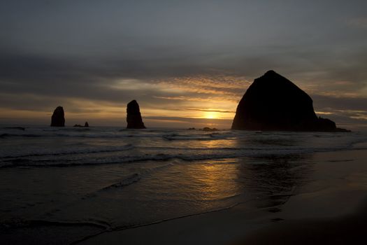 Sunset over Haystack Rock in Cannon Beach at Oregon Coast