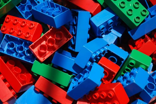 A colorful pile of connecting kids building blocks