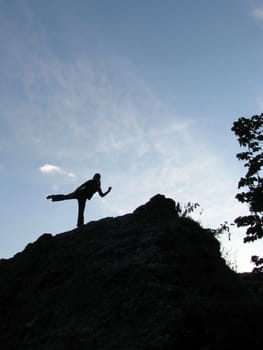 The sky, clouds, a rock, a stone, the person, a silhouette, people, trees, the nature, a landscape, a kind