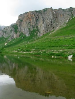 Mountains, rocks; a relief; a landscape; a hill; a panorama; Caucasus; top; lake, water, reflection, a slope; a snow