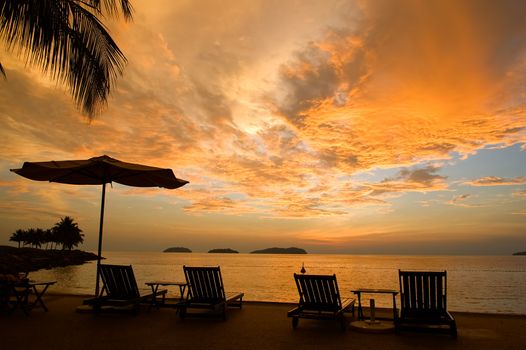 Silhouette of two relaxing seats at seashore