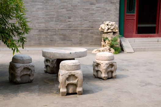 Stone made furnitures at the backyard of Chinese temple 