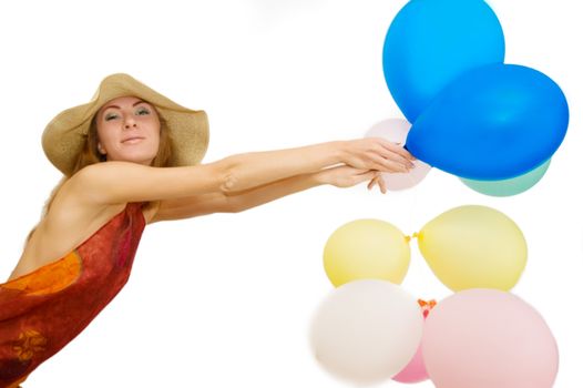 Smiling woman flying with bunch of balloons