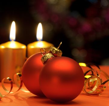 Christmas candles and red spheres. A celebratory composition