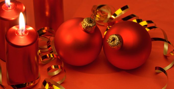 Christmas candles and red spheres. A celebratory composition