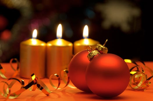 Christmas candles and red spheres. A celebratory composition