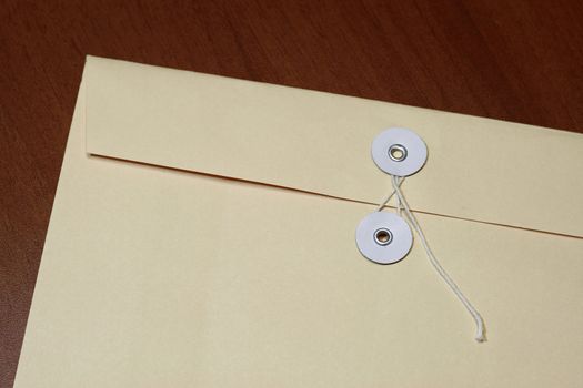 Manila envelope with string with table texture background