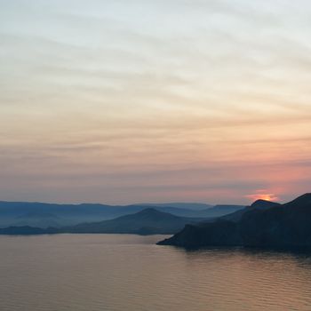 Colourful decline over mountains and the sea.