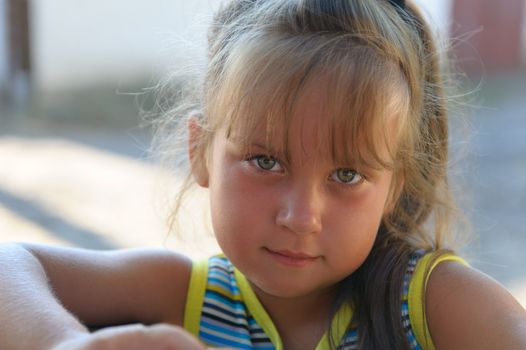 Portrait of the little girl close up. Outdoors