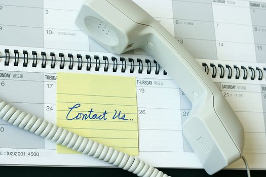 Contact us concept - with post it note telephone and planner calendar