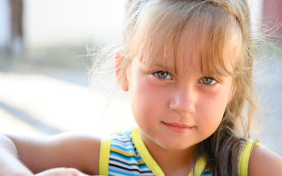 Portrait of the little girl close up. Outdoors