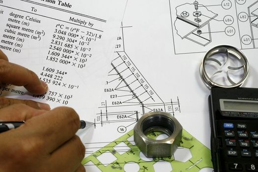 Mechanical Engineer with his tool and a table drafting works