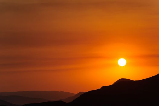 Colourful decline over mountains. Red colour