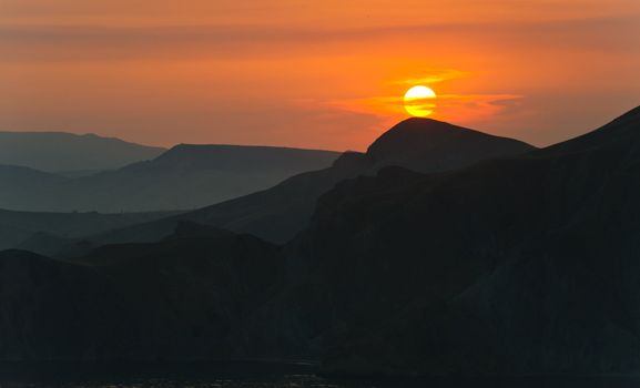 Colourful decline over mountains and the sea.