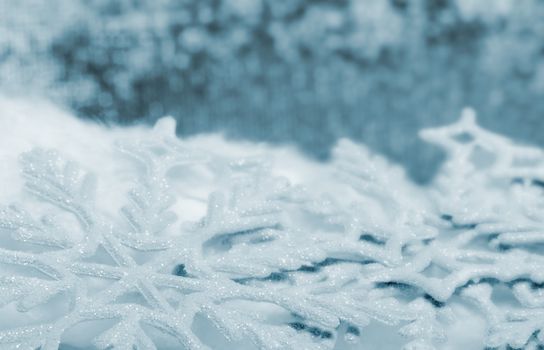 Snowflake big close up. Bokeh a background. Toning is blue