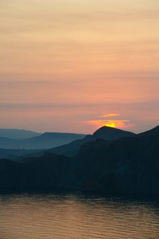 Colourful decline over mountains and the sea.