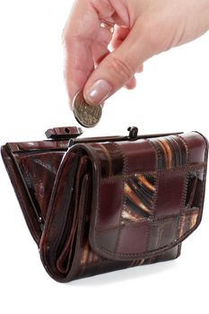 A female hand put into purse a coin isolated over white background