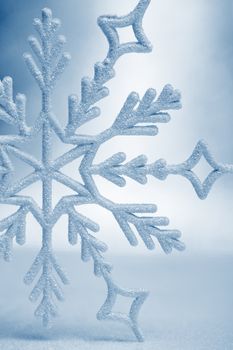 Snowflake big closeup. Bokeh a background. Toning is blue