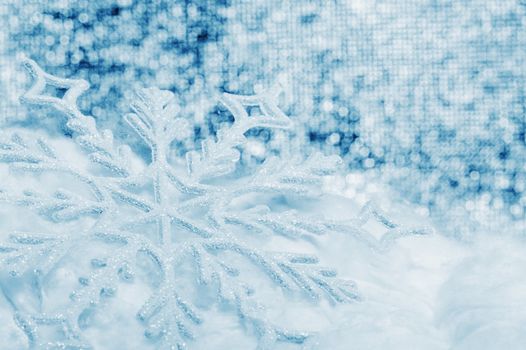 Snowflake big close up. Bokeh a background. Toning is blue