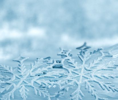 Snowflake big close up. Bokeh a background. Toning is blue