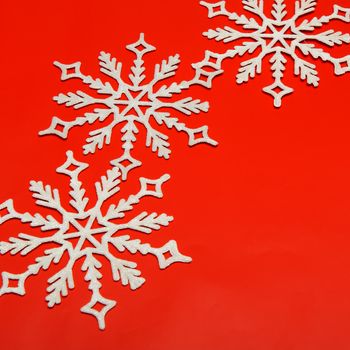 The big snowflake on a red background. Closeup