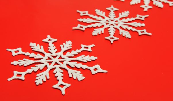 The big snowflake on a red background. Closeup