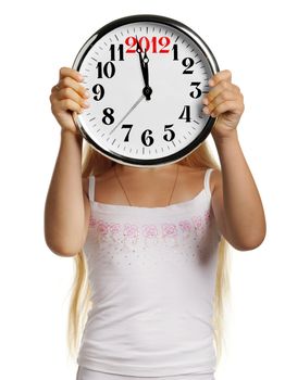 The girl hold in hands a big clock with figures 2012. It is isolated on a white background