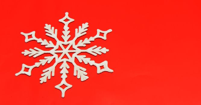 The big snowflake on a red background. Closeup