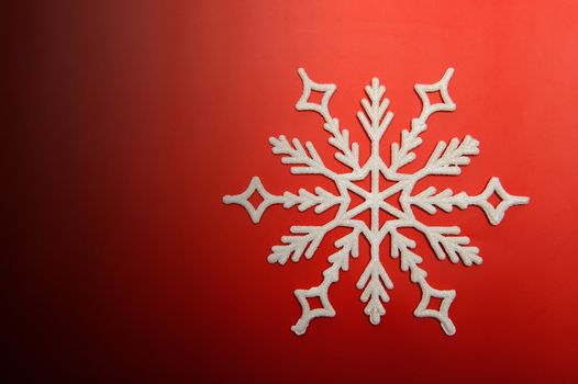 The big snowflake on a red background. Closeup