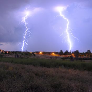 thunderstorm with lightnings and cloudy sky at rainy night