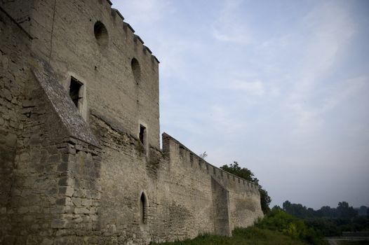 medieval city walls with grass and blue sky