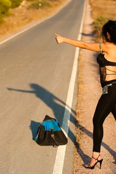 Sexy hitchhiker trying her luck on a lonely road