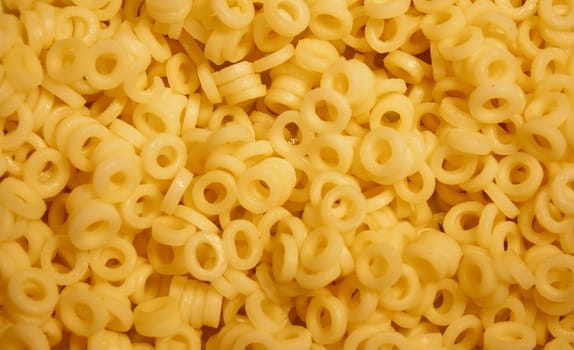 some macro shot of yellow round pasta