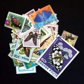 Pile of stamps with butterfly