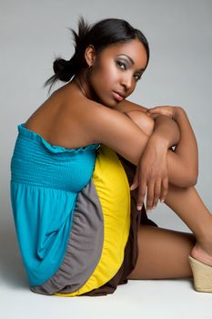 Beautiful young black woman sitting
