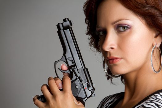 Sexy woman holding hand gun