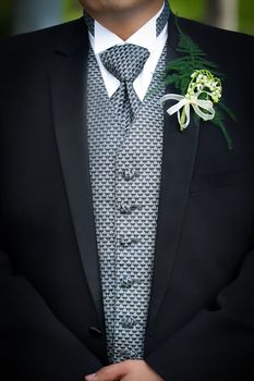 Groom with flower on  chest prepared for the wedding ceremony