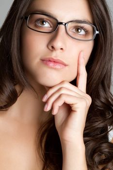 Beautiful thinking woman wearing glasses