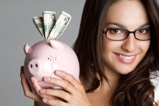 Smiling girl holding piggy bank money