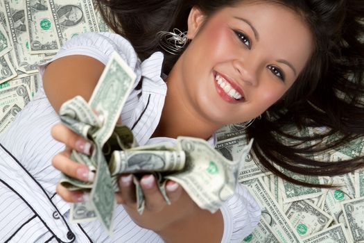 Smiling person laying in money